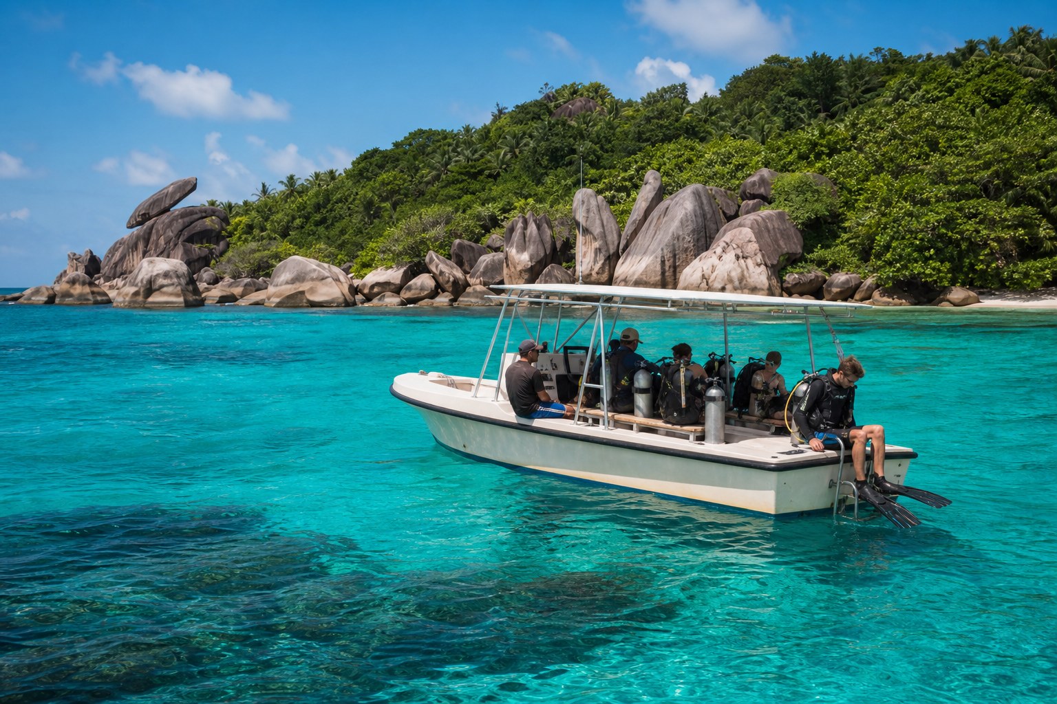 Bateau de plongée dans une eau calme près des rochers granitiques des Seychelles